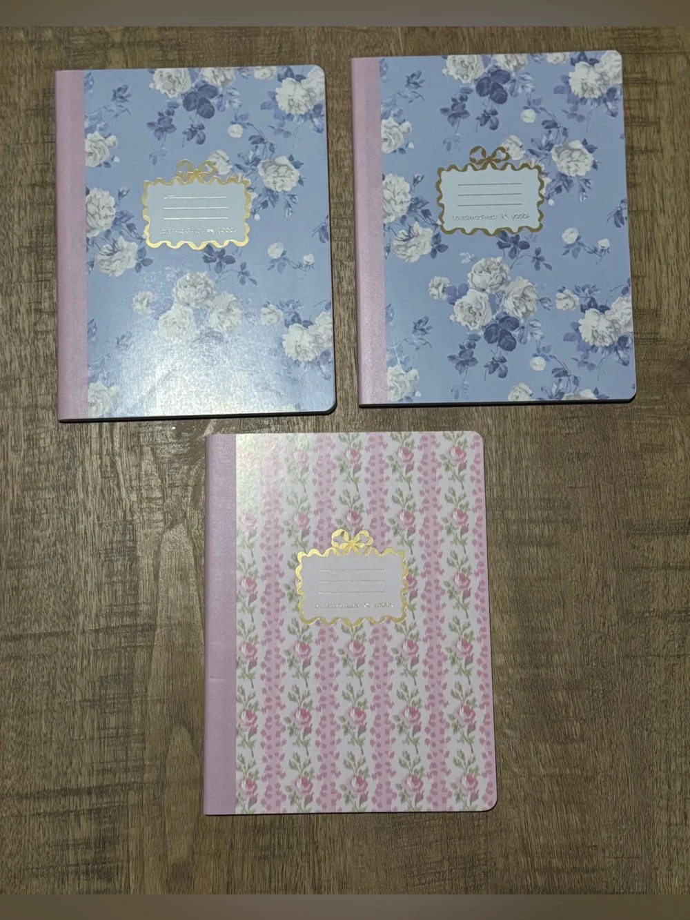 3 Loveshackfancy wide ruled composition notebooks. 1 pink and 2 blues.